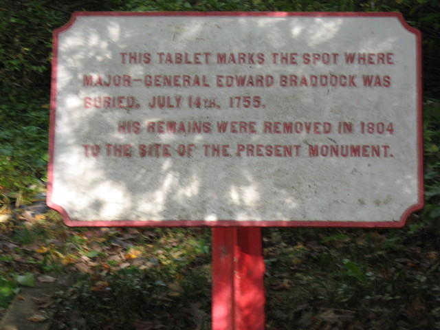 Sign marking Braddock's first grave site in the road