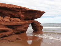 Backside (looking West) of red sandstone cliffs at Penderosa Beach with tide in (leaning part now gone)