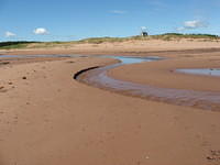 At high tide water runs into small lake.  At low tide (here) water running back from lake to sea